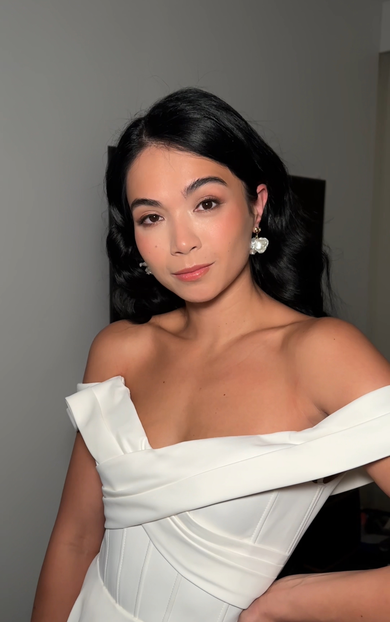 Woman in a white evening dress with soft makeup.