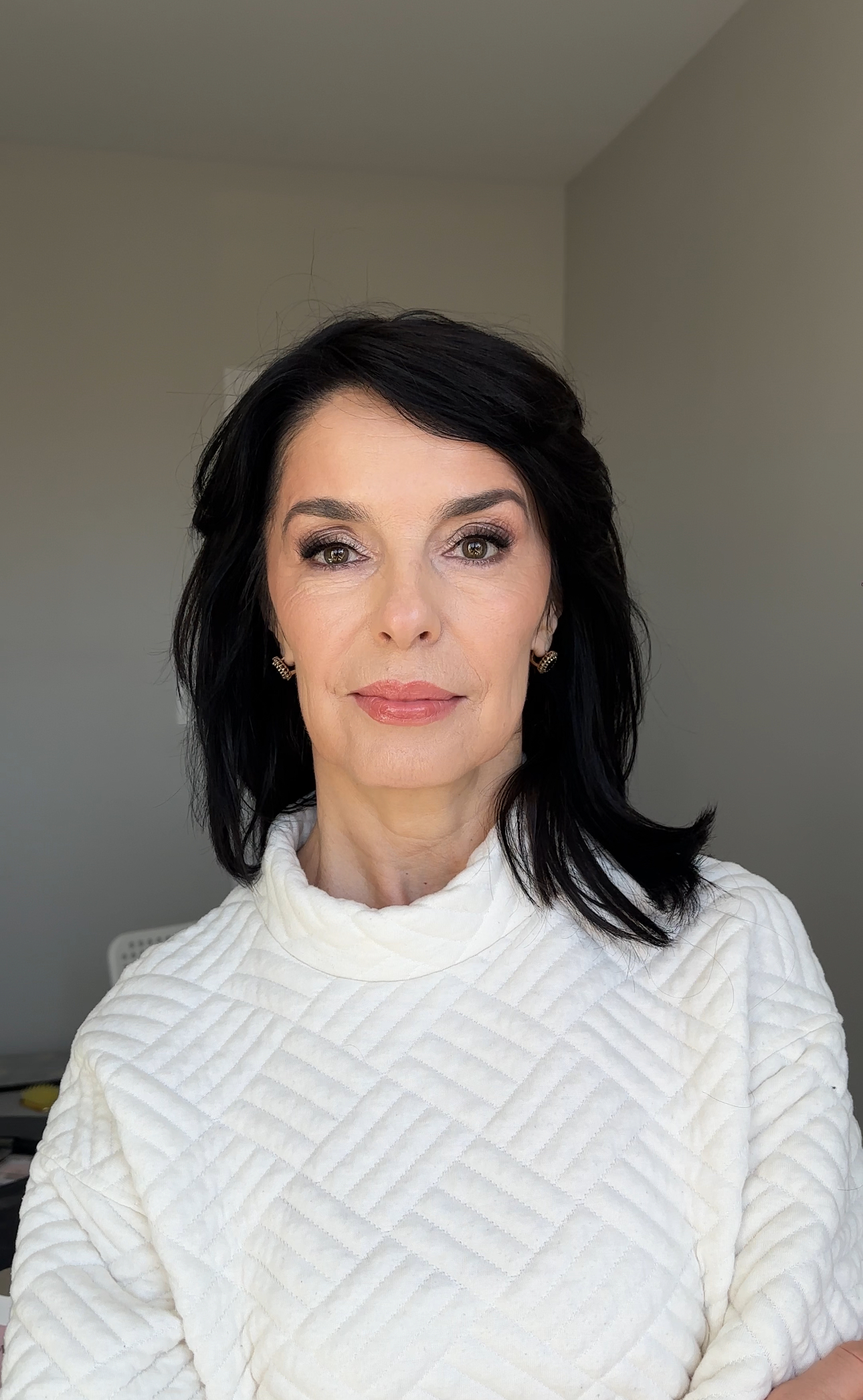 Soft lifting makeup for a mature client: taupe eyes and nude lips.