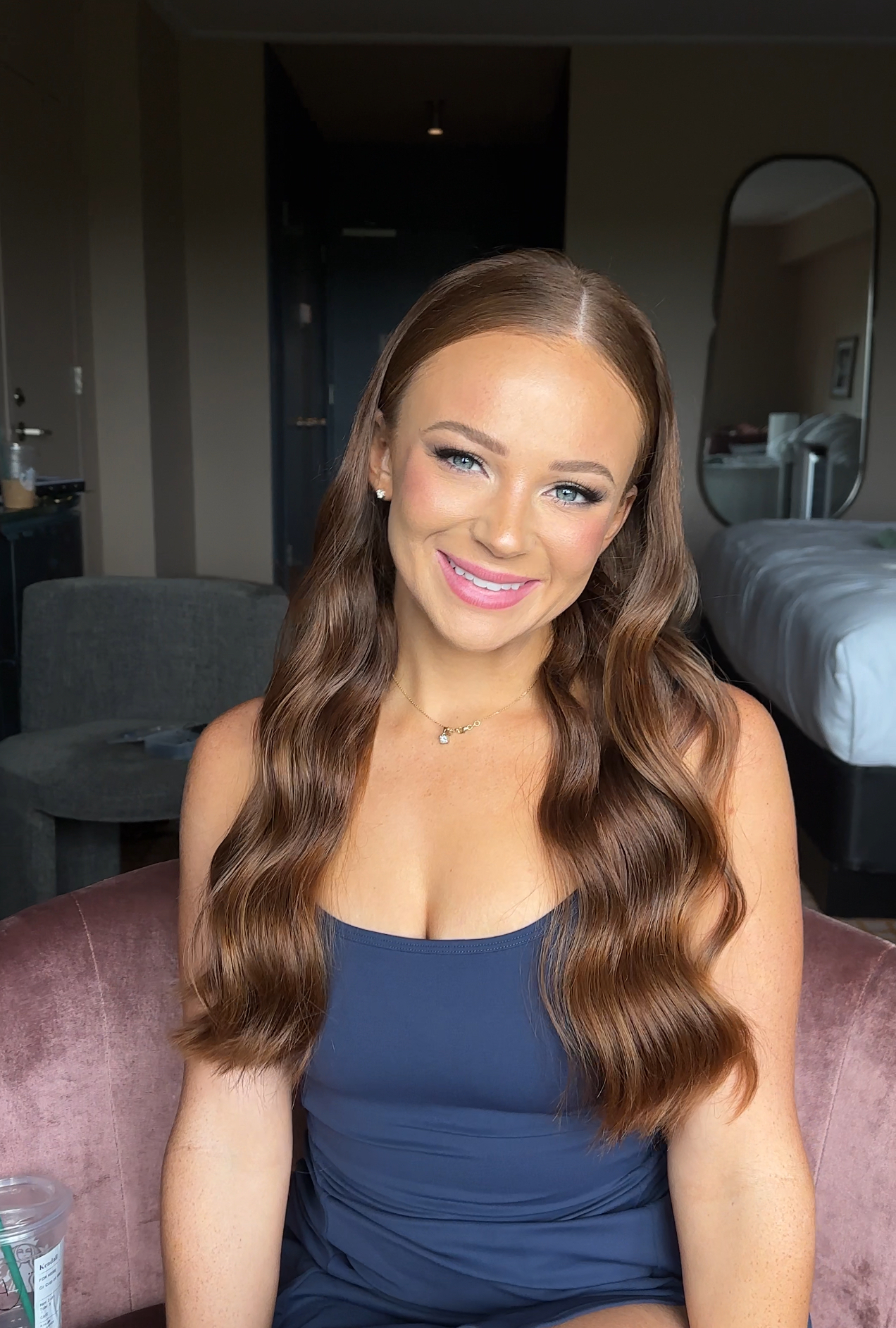 Long glossy waves with pink lipstick, natural soft-glam makeup.